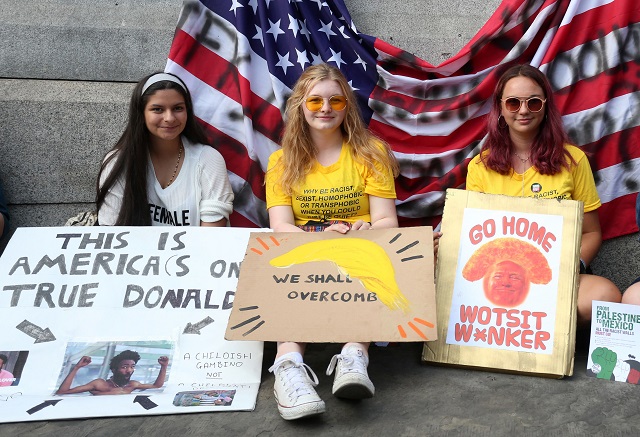 Protesters hold placards in Trafalgar Square as a demonstration against the UK visit of US President Donald Trump takes place in London on July 13, 2018. PHOTO: AFP