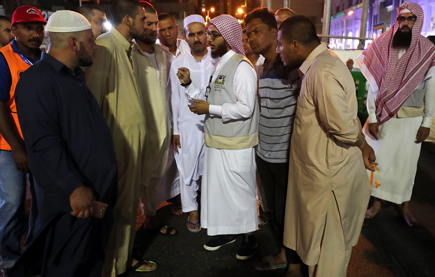 Muslim pilgrims speak to a translator in the Saudi holy city of Mecca. PHOTO:AFP