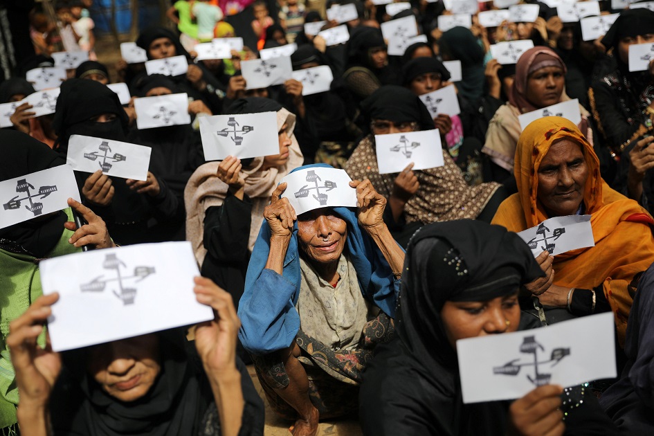 Rohingya refugee women hold placards as they take part in a protest at the Kutupalong refugee camp to mark the one-year anniversary of their exodus in Cox's Bazar, Bangladesh. 