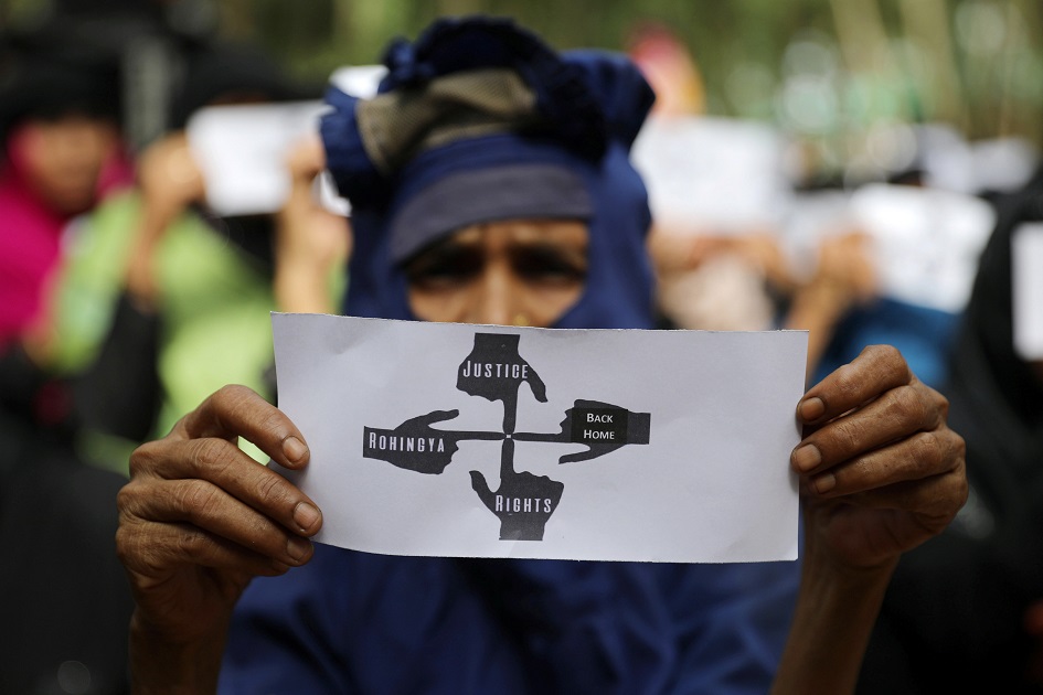 Rohingya refugee woman holds placard in protest. PHOTO: REUTERS 