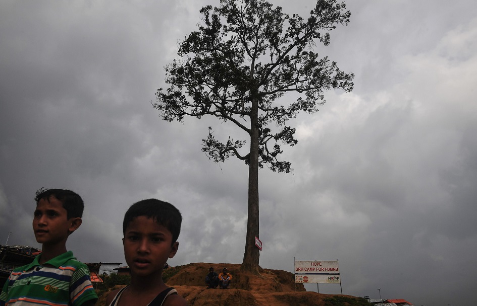 Young Rohingya refugees next to a lone tree on a hill at the Balukhali refugee camp in Ukhia in southern Bangladesh. PHOTO: AFP