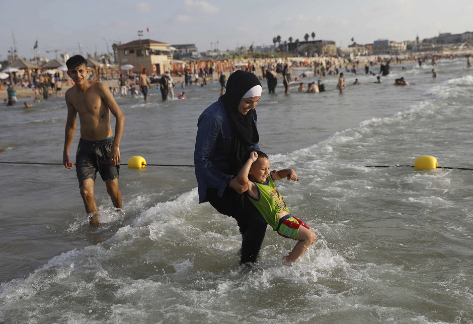 Palestinians play on the beach in Tel Aviv, Israel during Eidul Azha holidays on August 22, 2018. PHOTO:AFP