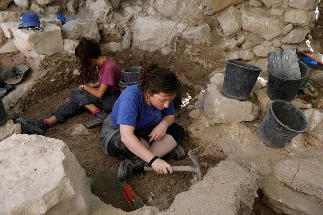 Israeli archeologists work at the site where a rare golden earring believed to be more than 2,000 years-old, discovered at the archeological site of the City of David in East Jerusalem near the walls of the old city on 8 August 2018. PHOTO: AFP