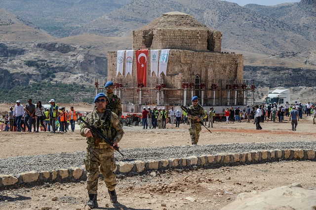 Tukish soldiers stand guard as the Artuklu Hamam, a centuries-old bath house weighing 1,600 tonnes, is loaded onto a wheeled platform an moved down a specially constructed road, on August 6, 2018. PHOTO: AFP