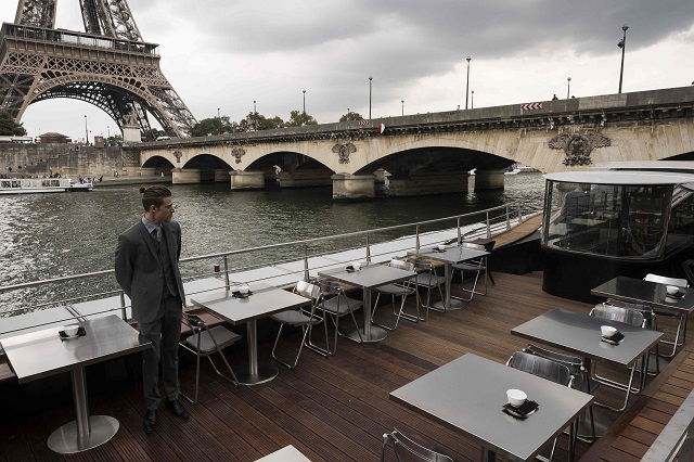 A waiter stands at French chef Alain Ducasse's new boat restaurant, the 