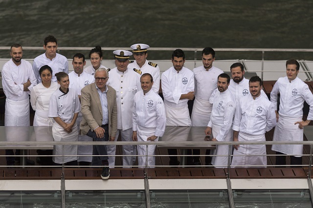 French chef Alain Ducasse (4thL) poses with his team on his new boat restaurant, the 