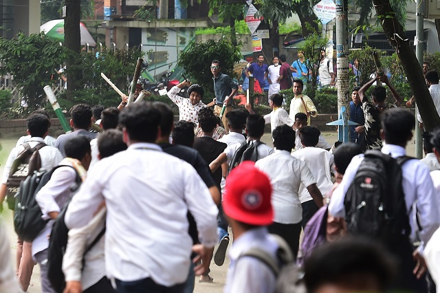 Bangladeshi students clash with an unidentified man during a student protest in Dhaka on August 4, 2018. PHOTO: AFP