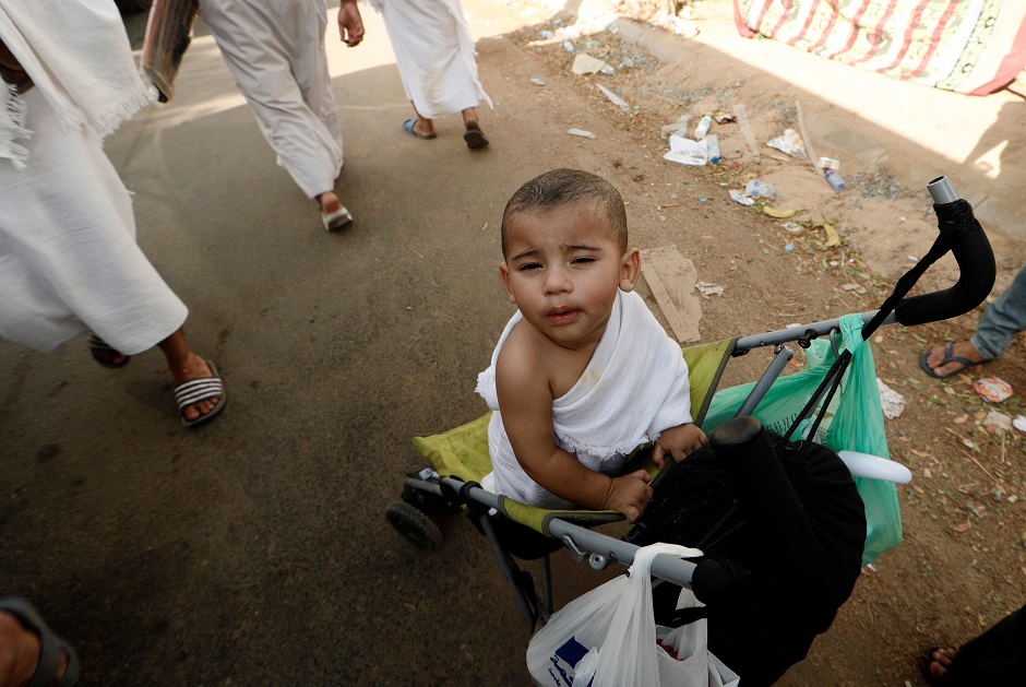 Mazen, aged one, gathers with his parents and other pilgrims on the plains of Arafat during Hajj on August 20, 2018. PHOTO:REUTERS