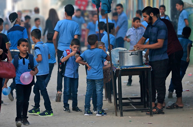 Puplis gather in front of a school run by the United Nations Agency for Palestinian Refugees (UNRWA) in Gaza City on August 29. PHOTO: AFP