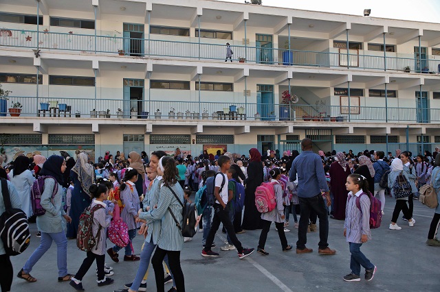 Children and teachers gather at the playground of a school run by United Nations agency for Palestinian refugees (UNRWA) in Balata refugee camp. PHOTO: AFP