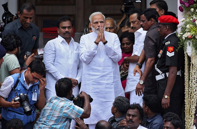 Indian Prime Minister Narendra Modi greets people as he arrives for the funeral of the Indian Tamil leader Muthuvel Karunanidhi in Chennai, India August 8, 2018. PHOTO: AFP