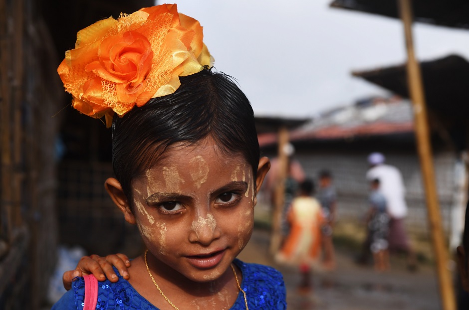 A young Rohingya regugee poses with her new clothes and painted face at Balukhali refugee camp in Bangladesh's Ukhia district on August 22, 2018. PHOTO:AFP