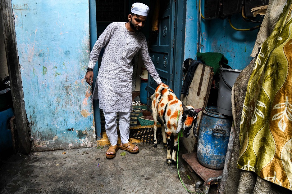 Indian Muslims prepare to sacrifice a goat after offering Eidul Azha prayers at the Jama Masjid in New Delhi on August 22. PHOTO:AFP