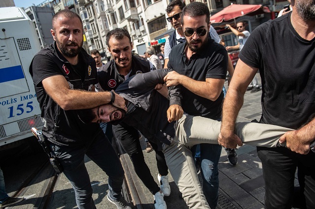 Turkish riot police detains a protester of Saturday mothers group demonstration on August 25, 2018 in Istanbul. PHOTO: AFP