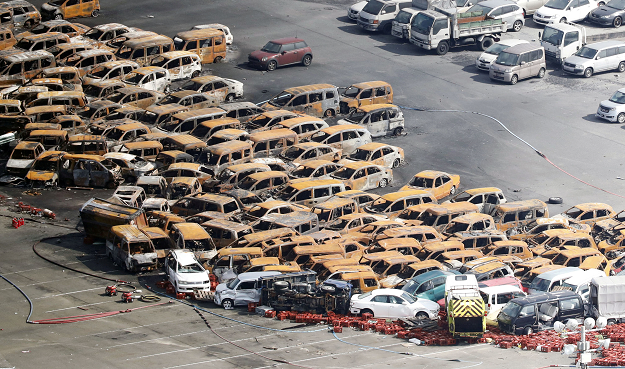  Burned cars are seen on an artificial island after Typhoon Jebi hit the area. PHOTO:REUTERS