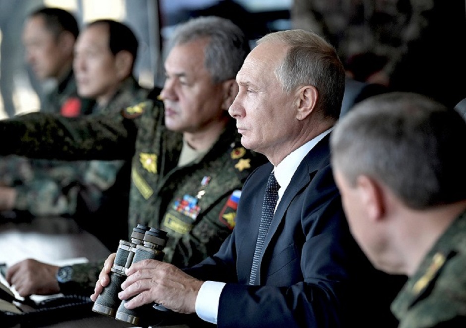 Russia's President Vladimir Putin (C), Defence Minister Sergei Shoigu (L) and Chief of the General Staff of the Russian Armed Forces Valery Gerasimov watch the Vostok-2018 (East-2018) military drills at Tsugol training ground PHOTO: AFP