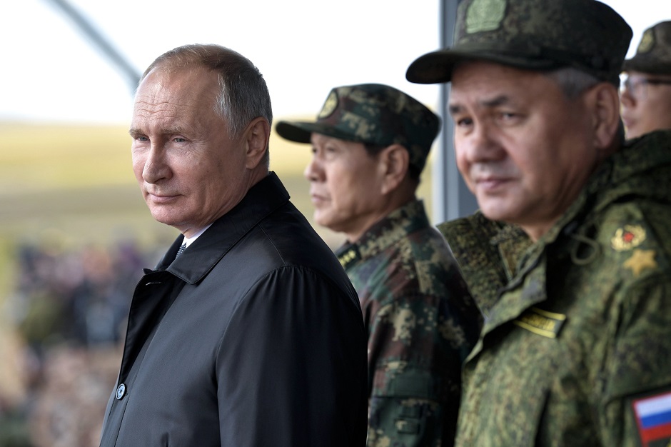 Russia's President Vladimir Putin (L), China's Defense Minister Wei Fenghe (C) and Russian Defence Minister Sergei Shoigu watch the parade of the participants of the Vostok-2018 PHOTO: AFP