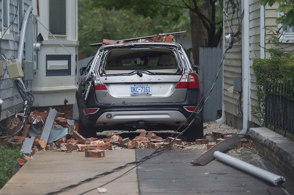 A car is destroyed from falling bricks as Hurricane Florence passes over Wilmington PHOTO: AFP