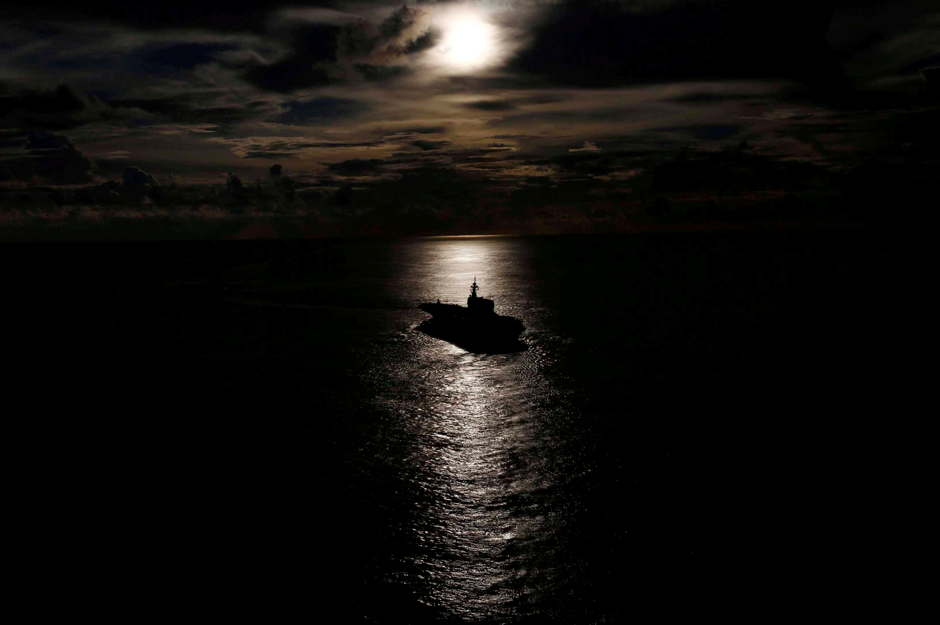 Japanese helicopter carrier Kaga is silhouetted against the reflection of the sun on the ocean during a joint naval drill with British frigate HMS Argyll and Japanese destroyer Inazuma in the Indian Ocean. Reuters 