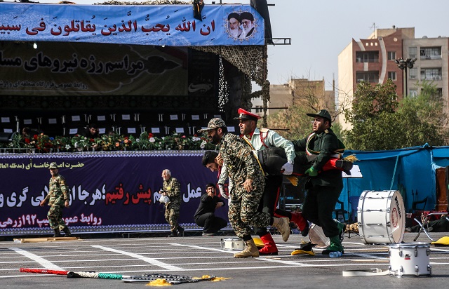 This picture taken on September 22, 2018 in the southwestern Iranian city of Ahvaz shows Iranian soldiers carrying away an injured comrade. PHOTO: AFP