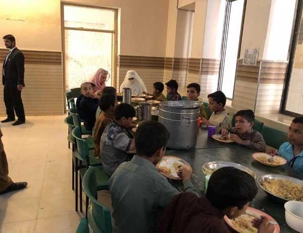 Bushra bibi shares a meal of chicken biryani and zarda with the children of the orphanage. PHOTO:EXPRESS