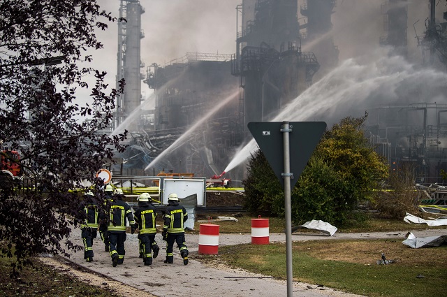 ireworkers work the site of a refinery of Bayernoil company where an explosion took place on early September 01, 2018. PHOTO: AFP