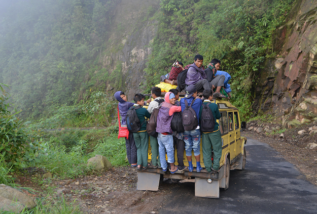 Indian villagers and school children on an overcrowded vehicle as they travel to Kongthong. PHOTO: AFP 