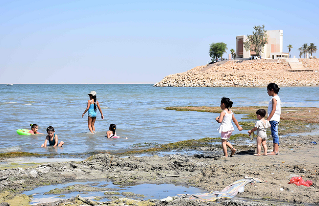 Iraqi children swim by the shore of Lake Habbaniyah PHOTO AF P