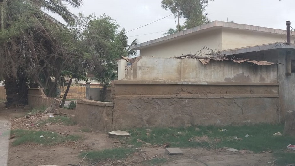 A boundary wall has fallen down in the residence area due to no sewage system. PHOTO: SAFDAR RIZVI/EXPRESS