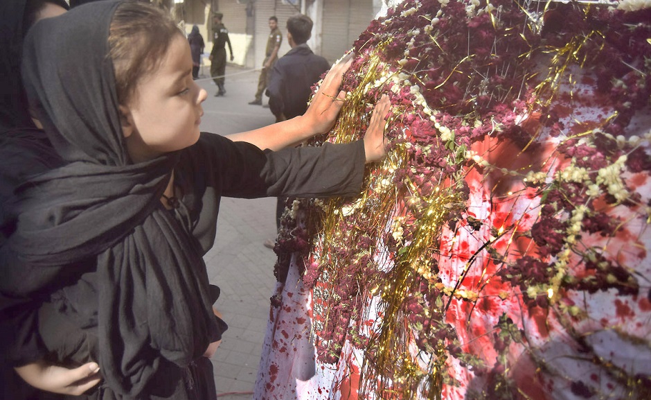 A girl touches the Zuljinnah in a Muharram procession in Lahore on September 19, 2018. PHOTO:NNI