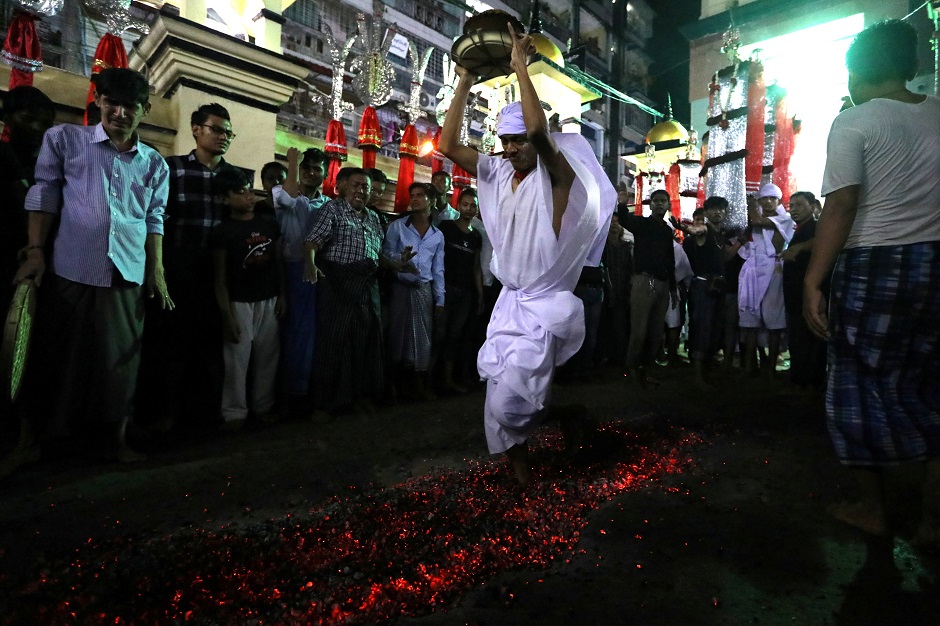 Shia Muslims walk on hot coals during the Ashura festival at a mosque in central Yangon, Myanmar on September 18, 2018. PHOTO:AFP