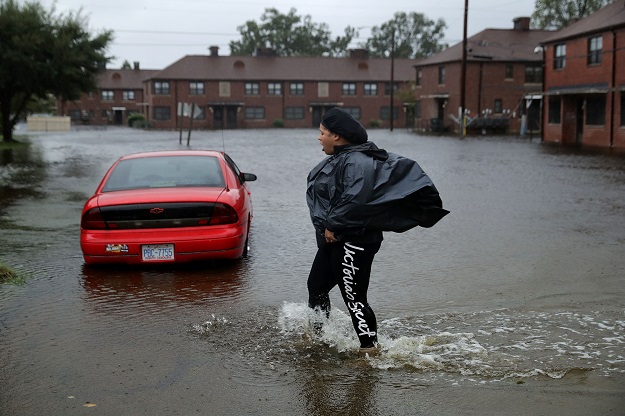 NEW BERN, NC - SEPTEMBER 13: Residents try to prepare for more floodwaters at the Trent Court public housing apartments after the Neuse River went over its banks during Hurricane Florence September 13, 2018 in New Bern, United States. Coastal cities in North Carolina, South Carolina and Virginia are under evacuation orders as the Category 2 hurricane approaches the United States. PHOTO: AFP