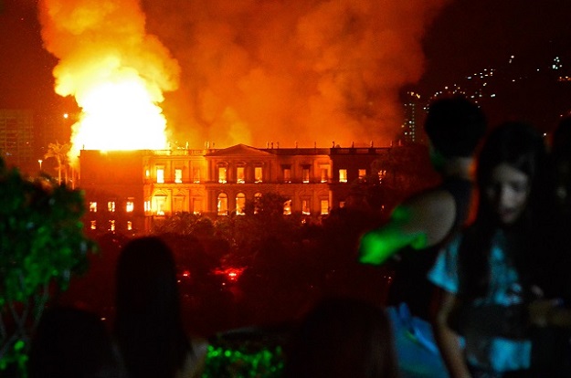 Five hours after an inferno ignited at a treasured Rio museum, firefighters were still trying to extinguish the flames completely. PHOTO: AFP