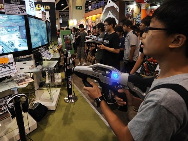 Children play the latest video games at the 13th Ani-Com comic book and game gair in Hong Kong on July 29, 2011. PHOTO: AFP