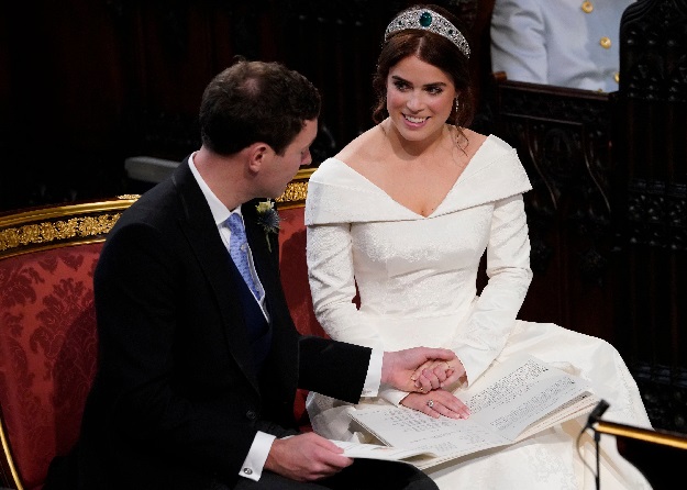 Britain's Princess Eugenie of York (R) reacts as she looks towards Jack Brooksbank during their wedding at St George's Chapel, Windsor Castle, in Windsor. PHOTO AFP