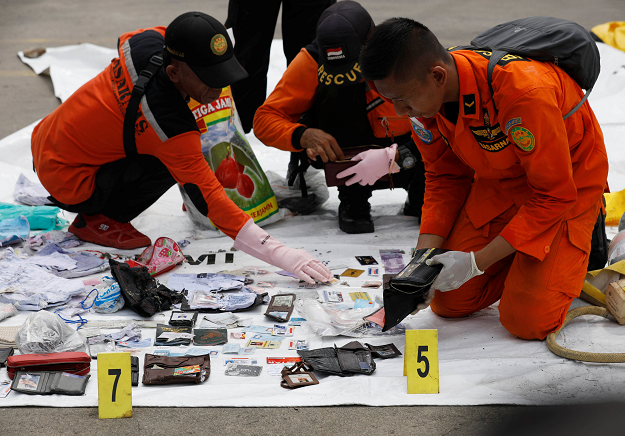  Rescue workers lay out recovered belongings believed to be from the crashed Lion Air flight JT610. PHOTO: REUTERS