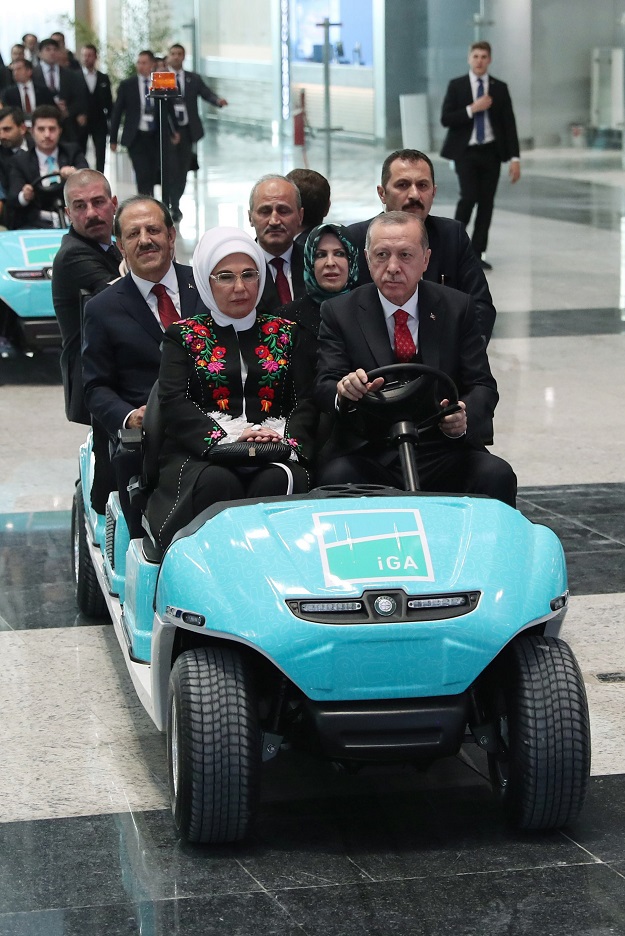 A handout picture taken and released on October 29, 2018 by the Turkish Presidential Press Service shows Turkish President Recep Tayyip Erdogan (front R) his wife Emine Erdogan (front L) and other officials driving in a vehicle on the opening day of the Istanbul New Airport in Istanbul. - Erdogan opened Istanbul's new international airport, which his government says will eventually become the world's largest, with great fanfare on October 29. PHOTO: AFP