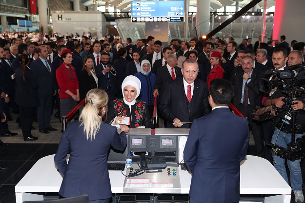 A handout picture taken and released on October 29, 2018 by the Turkish Presidential Press Service shows Turkish President Recep Tayyip Erdogan (L) and his wife Emine Erdogan (R)doing a symbolic check-in and taking their tickets on the opening day of the Istanbul New Airport in Istanbul. - Erdogan opened Istanbul's new international airport, which his government says will eventually become the world's largest, with great fanfare on October 29. PHOTO: AFP