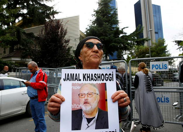 A human rights activist holds picture of Saudi journalist Jamal Khashoggi during a protest outside the Saudi Consulate in Istanbul, Turkey October 9, 2018. PHOTO: REUTERS