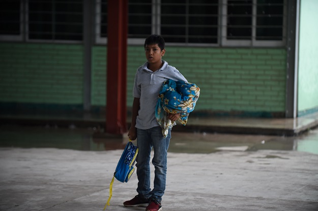 A boy prepares to settle in a shelter in Escuinapa, Sinaloa state, Mexico, on October 23, 2018, before the arrival of Hurricane Willa. - Mexico braced Tuesday for the impact of Hurricane Willa as the Category 3 storm barrelled toward its Pacific Coast with what forecasters warned would be potentially deadly force. PHOTO: AFP
