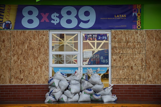 View of a storefront with wood panels and sand bags for protection, as the Hurricane Willa arrives at the Mazatlan port in Sinaloa state, Mexico, on October 23, 2018. - Hurricane Willa was upgraded to a 