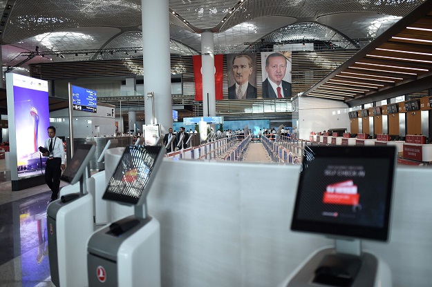 Turkish president Recep Tayyip Erdogan (R) and modern Turkey's founder Mustafa Kemal Ataturk's (L) pictures are seen during the opening ceremony of Istanbul's third airport, the Istanbul New Airport, in the Arnavutkoy district on the European side of Istanbul on October 29, 2018. PHOTO: AFP
