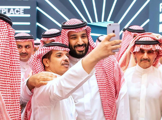 A handout picture provided by the Saudi Royal Palace on October 23, 2018 shows Crown Prince Mohammed bin Salman (centre) posing for a selfie near Saudi billionaire Prince Al-Walid bin Talal (right) during the Future Investment Initiative conference. PHOTO: AFP