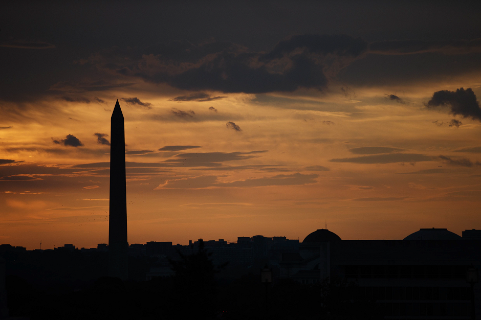 The sun sets behind the Washington Monument, October 4, 2018 in Washington, DC. AFP