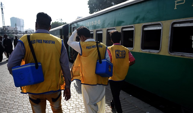 health workers arrive at a railway station to administer polio vaccine drops to children during a vaccination campaign in karachi on sept 24 2018 photo afp