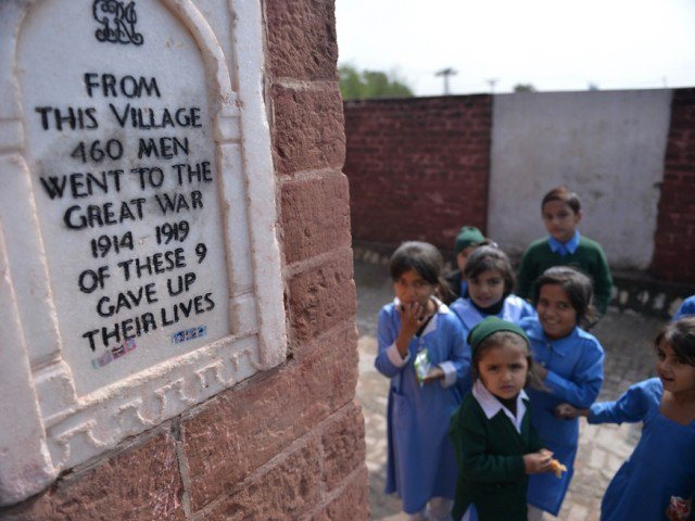 in this photograph taken on october 29 2014 schoolchildren stand beside a monument of the veterans of wwi at a school in the village of dulmial in chakwal district some 150kms south of islamabad photo afp