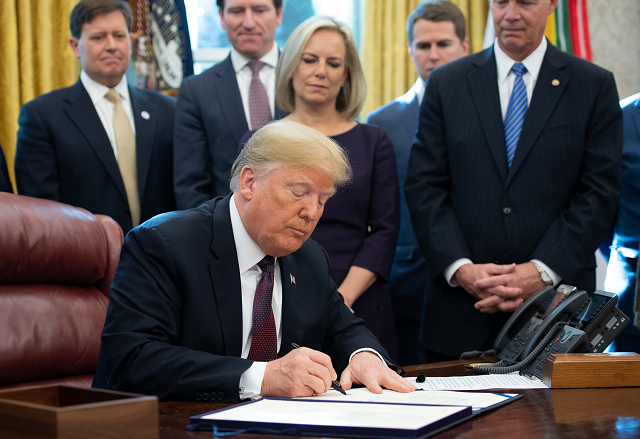 us president donald trump signs the cybersecurity and infrastructure security agency act in the oval office of the white house in washington dc november 16 2018 photo afp