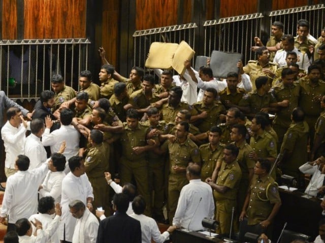 Brawling erupted in parliament with Rajapakse loyalists smashing furniture, throwing chilli powder and projectiles at rivals in a bid to disrupt a no-confidence motion against the disputed prime minister. PHOTO AFP