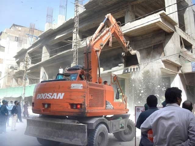 Karachi Metropolitan Corporation's anti encroachment team demolishes a newly constructed building at Empress Market, Saddar. PHOTO: EXPRESS