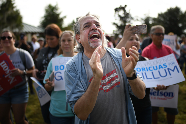 Supporters listen to Senator Bill Nelson, as he campaigns at the 65th Infantry Veterans Park. PHOTO: AFP